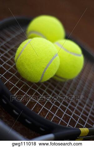 Close-up of three tennis balls on a tennis racket View Large Photo Image Stock Photo - Close-up of three tennis balls on a tennis racket. Fotosearch