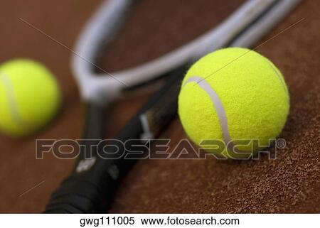 Stock Photography - Close-up of two tennis balls and a tennis racket. Fotosearch