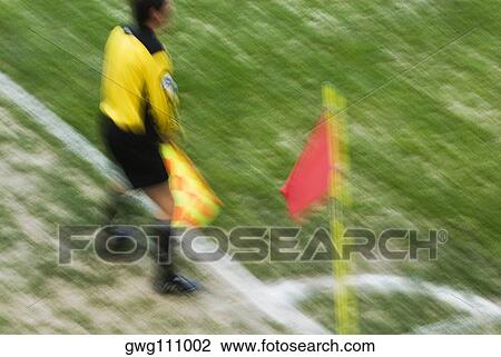High angle view of a referee standing and holding a flag View Large Photo Image Stock Image - High angle view of a referee standing and holding a flag. Fotosearch