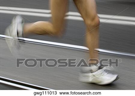Low section view of a male athlete running on a running track View Large Photo Image Stock Image - Low section view of a male athlete running on a running track. Fotosearch