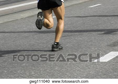 Low section view of a male athlete running on a running track View Large Photo Image Stock Image - Low section view of a male athlete running on a running track. Fotosearch