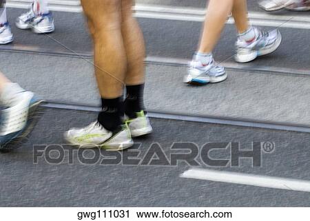 Low section view of male athletes preparing for a sports race on a running track View Large Photo Image Stock Image - Low section view of male athletes preparing for a sports race on a running track. Fotosearch
