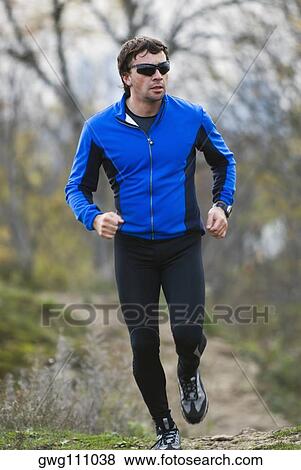 Mid adult man running View Large Photo Image Stock Photo - Mid adult man running. Fotosearch