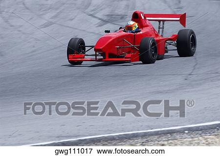 Person driving a formula one racing car on a motor racing track View Large Photo Image Stock Photo - Person driving a formula one racing car on a motor racing track. Fotosearch