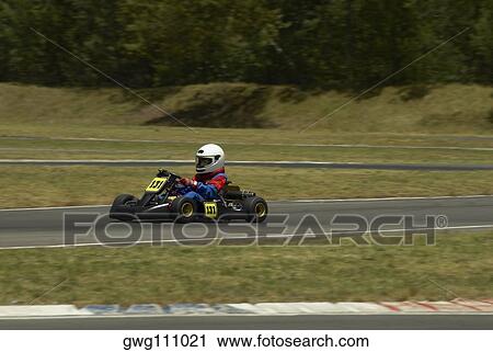 Person go-carting on a motor racing track View Large Photo Image Stock Image - Person go-carting on a motor racing track. Fotosearch
