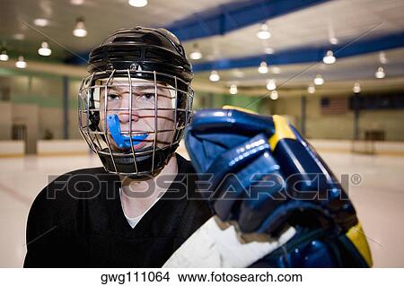 Portrait of an ice hockey player in the ice rink View Large Photo Image Picture - Portrait of an ice hockey player in the ice rink. Fotosearch