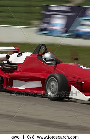 Racecar racing on a motor racing track View Large Photo Image Stock Photo - Racecar racing on a motor racing track. Fotosearch