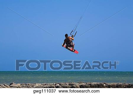 Rear view of a man kite boarding, Smathers Beach, Key West, Florida, USA View Large Photo Image Stock Photo - Rear view of a man kite boarding, Smathers Beach, Key West, Florida, USA. Fotosearch