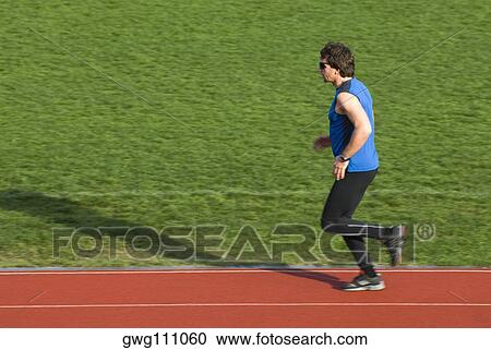 Side profile of a mid adult man running on a running track View Large Photo Image Stock Image - Side profile of a mid adult man running on a running track. Fotosearch