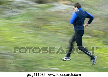 Side profile of a mid adult man running View Large Photo Image Stock Image - Side profile of a mid adult man running. Fotosearch