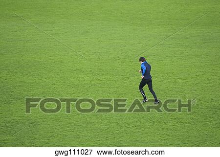 Side profile of a mid adult man running in a field View Large Photo Image Stock Photo - Side profile of a mid adult man running in a field. Fotosearch
