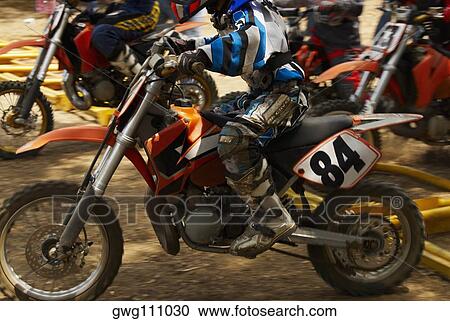 Side profile of motocross riders riding motorcycles View Large Photo Image Stock Image - Side profile of motocross riders riding motorcycles. Fotosearch