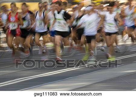 Stock Image - Track athletes running on a running track. Fotosearch