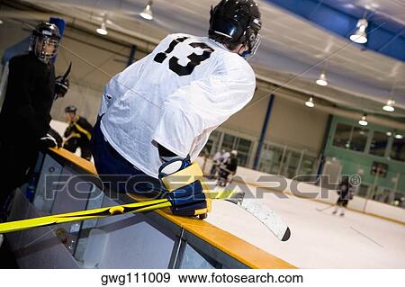 Two ice hockey players watching ice hockey View Large Photo Image Stock Photo - Two ice hockey players watching ice hockey. Fotosearch