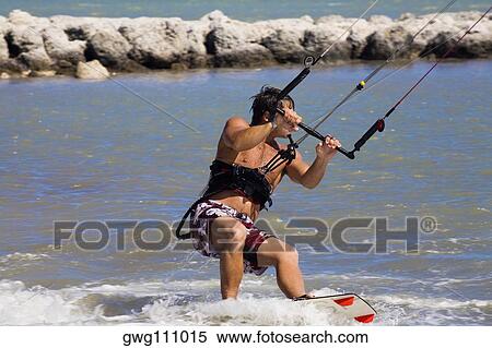 Young man kite boarding in the sea, Smathers Beach, Key West, Florida, USA View Large Photo Image Stock Photography - Young man kite boarding in the sea, Smathers Beach, Key West, Florida, USA. Fotosearch