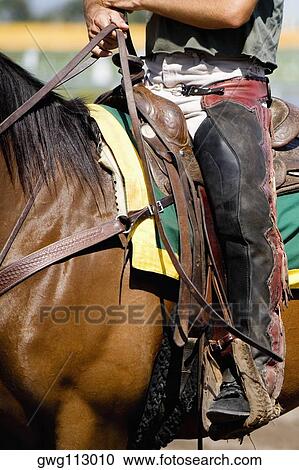 Low section view of a jockey riding a racehorse View Large Photo Image Stock Image - Low section view of a jockey riding a racehorse. Fotosearch