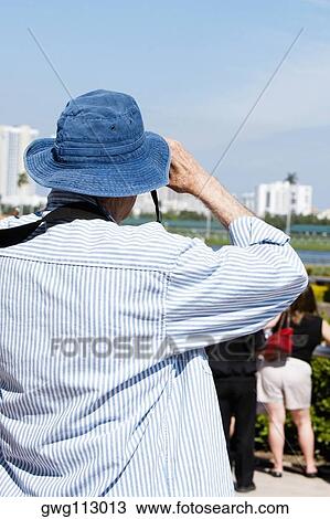 Rear view of spectators watching at the horseracing track View Large Photo Image Stock Image - Rear view of spectators watching at the horseracing track. Fotosearch