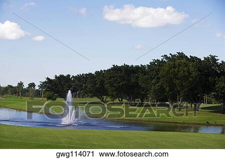Fountain in a golf course View Large Photo Image Stock Image - Fountain in a golf course. Fotosearch