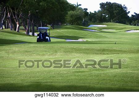 Golf cart in a golf course View Large Photo Image Stock Image - Golf cart in a golf course. Fotosearch