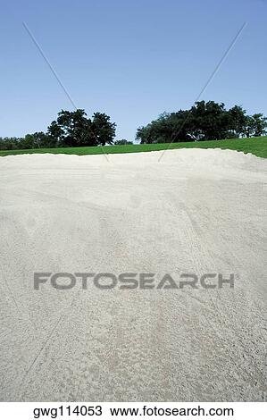 Stock Image - Sand trap in a golf course. Fotosearch