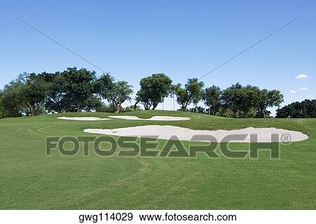 Sand trap in a golf course View Large Photo Image Stock Photo - Sand trap in a golf course. Fotosearch