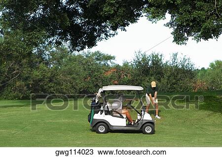 Two men playing golf in a golf course View Large Photo Image Stock Image - Two men playing golf in a golf course. Fotosearch
