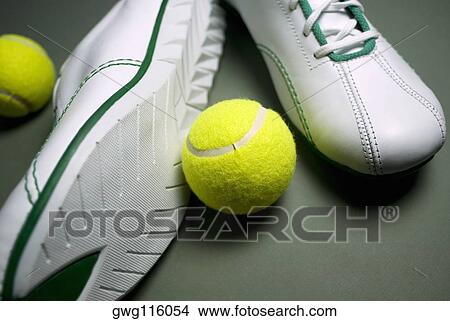 Close-up of a pair of shoes with two tennis balls View Large Photo Image Picture - Close-up of a pair of shoes with two tennis balls. Fotosearch