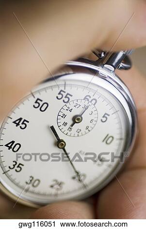 Close-up of a person's hand holding a stopwatch View Large Photo Image Stock Image - Close-up of a person's hand holding a stopwatch. Fotosearch