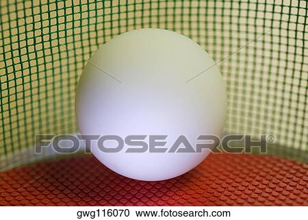 Stock Image - Close-up of a table tennis ball on a red table tennis racket. Fotosearch
