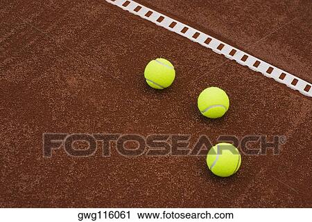 Close-up of three tennis balls in a court View Large Photo Image Stock Image - Close-up of three tennis balls in a court. Fotosearch
