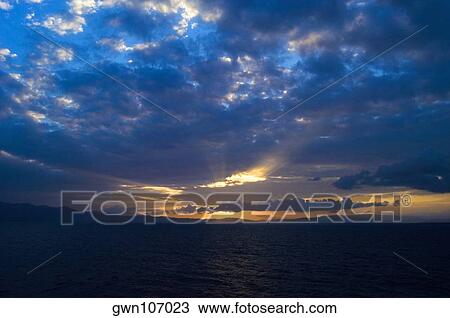 Cloudscape over the sea at dusk, Milne Bay, Papua New Guinea View Large Photo Image Stock Image - Cloudscape over the sea at dusk, Milne Bay, Papua New Guinea. Fotosearch