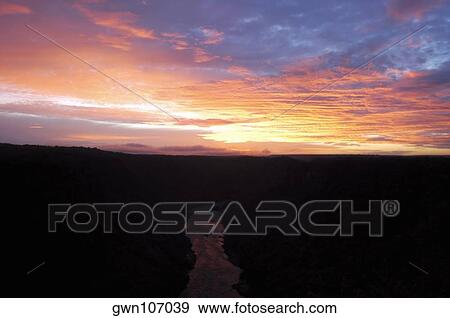 High angle view of a river passing through mountains at sunset, Zambezi River, Zimbabwe View Large Photo Image Stock Photo - High angle view of a river passing through mountains at sunset, Zambezi River, Zimbabwe. Fotosearch