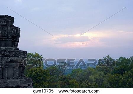 Stock Image - Old ruins of a temple at sunset, Phnom Bakeng, Angkor, Siem Reap, Cambodia. Fotosearch