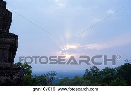 Stock Photograph - Old ruins of a temple at sunset, Phnom Bakeng, Angkor, Siem Reap, Cambodia. Fotosearch