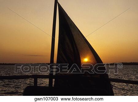 Silhouette of a sailboat in the sea at sunset, Pemba, Tanzania View Large Photo Image Stock Image - Silhouette of a sailboat in the sea at sunset, Pemba, Tanzania. Fotosearch