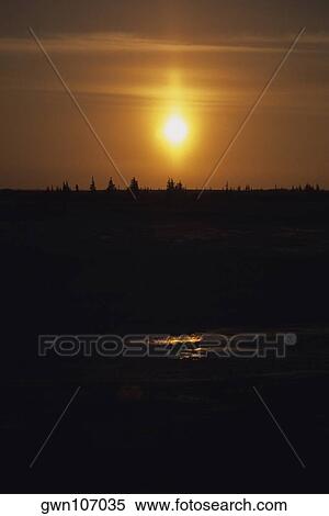 Stock Photography - Sunset over a forest, Churchill, Manitoba, Canada. Fotosearch