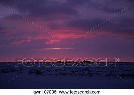 Stock Photograph - Sunset over a frozen landscape, Churchill, Manitoba, Canada. Fotosearch