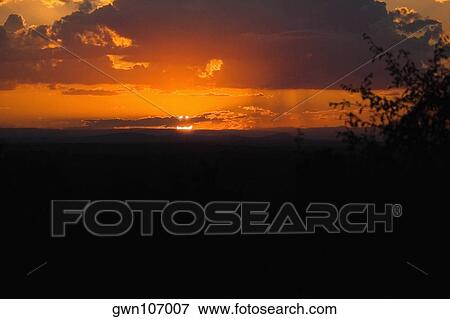 Stock Photo - Sunset over a landscape, Kruger National Park, South Africa. Fotosearch