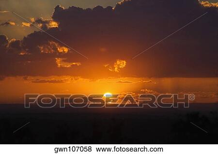 Stock Photo - Sunset over a landscape, Kruger National Park, South Africa. Fotosearch