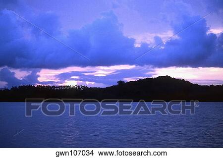 Picture - Sunset over an ocean, New Britain, Papua New Guinea. Fotosearch
