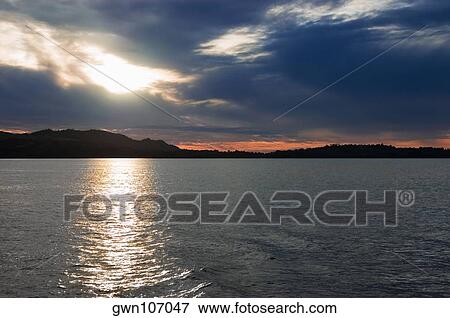 Sunset over the sea, Lembeh Strait, Sulawesi, Indonesia View Large Photo Image Stock Photo - Sunset over the sea, Lembeh Strait, Sulawesi, Indonesia. Fotosearch
