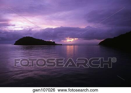 Stock Photograph - Sunset over the sea, Makogai Island, Fiji. Fotosearch