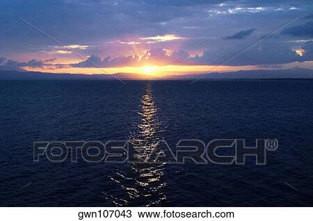 Sunset over the sea, Milne Bay, Papua New Guinea View Large Photo Image Stock Image - Sunset over the sea, Milne Bay, Papua New Guinea. Fotosearch