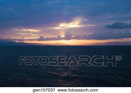 Sunset over the sea, Milne Bay, Papua New Guinea View Large Photo Image Stock Photo - Sunset over the sea, Milne Bay, Papua New Guinea. Fotosearch