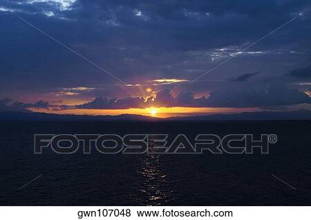 Sunset over the sea, Milne Bay, Papua New Guinea View Large Photo Image Stock Photo - Sunset over the sea, Milne Bay, Papua New Guinea. Fotosearch