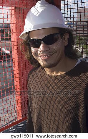 Stock Image - Close-up of a male construction worker smiling. Fotosearch