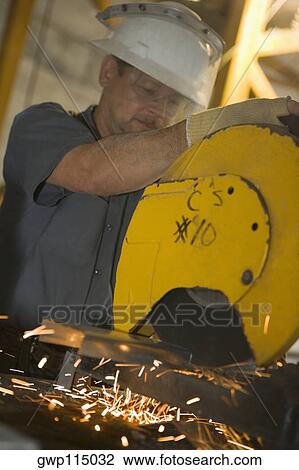 Close-up of a male construction worker working at a construction site View Large Photo Image Stock Image - Close-up of a male construction worker working at a construction site. Fotosearch