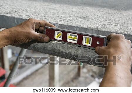 Close-up of a person's hand holding a level View Large Photo Image Stock Photo - Close-up of a person's hand holding a level. Fotosearch