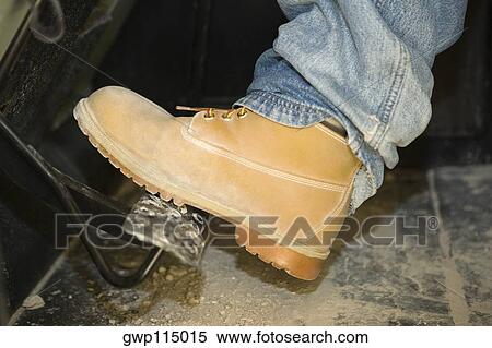 Stock Photography - Close-up of a person's leg on a brake. Fotosearch