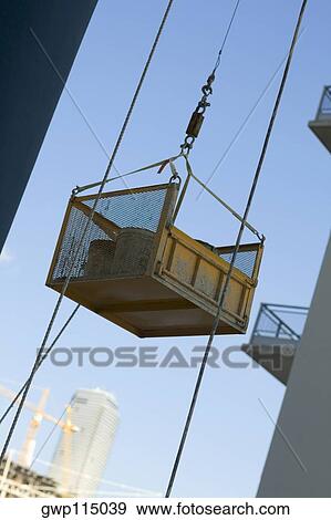 Stock Photo - Container attached to the pulley of a lift. Fotosearch